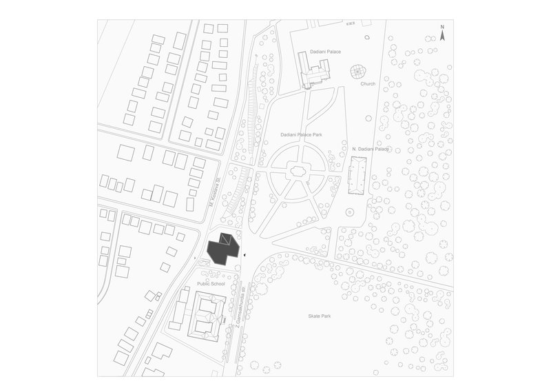 Site plan drawing showing building footprint adjacent to park with pathways and tree canopies