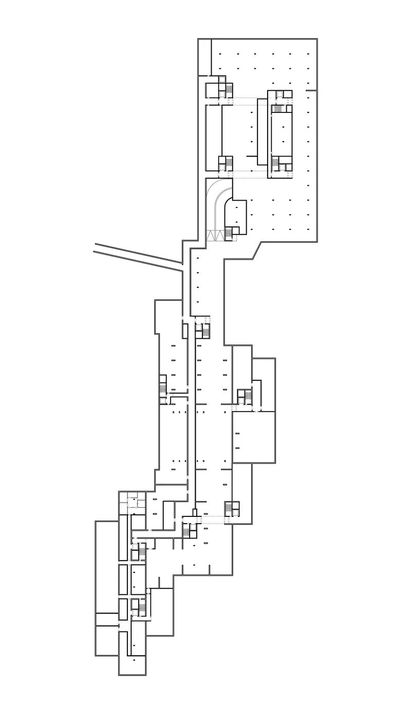 Floor plan drawing showing a linear arrangement of interconnected volumes with interior partitions