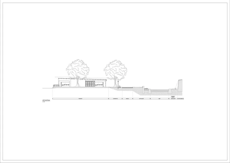 Elevation drawing depicting the low horizontal building profile with two trees flanking the perforated brick facade