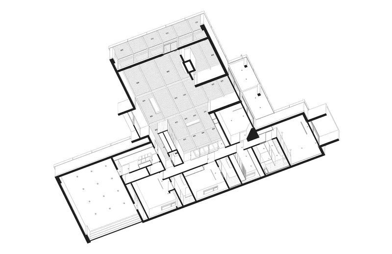 Floor plan drawing revealing open living spaces and a grid of rooms along the perimeter