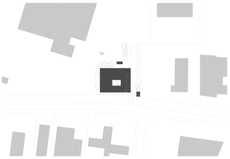 Site plan drawing showing building footprint with central courtyard surrounded by trees and adjacent structures