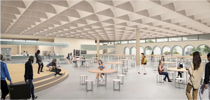Multi-functional cafeteria designed as a social hub blending dining, performance, and informal learning.