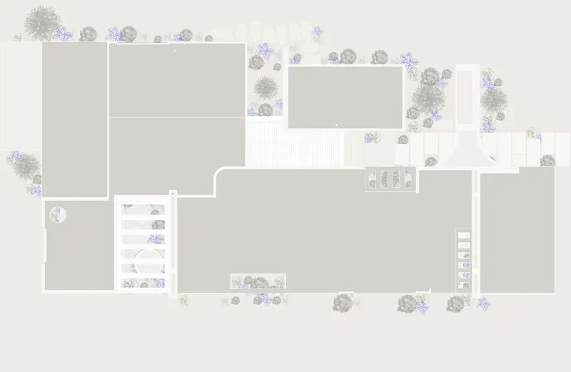 Site plan drawing showing rectangular building volumes surrounded by scattered trees and landscaped areas