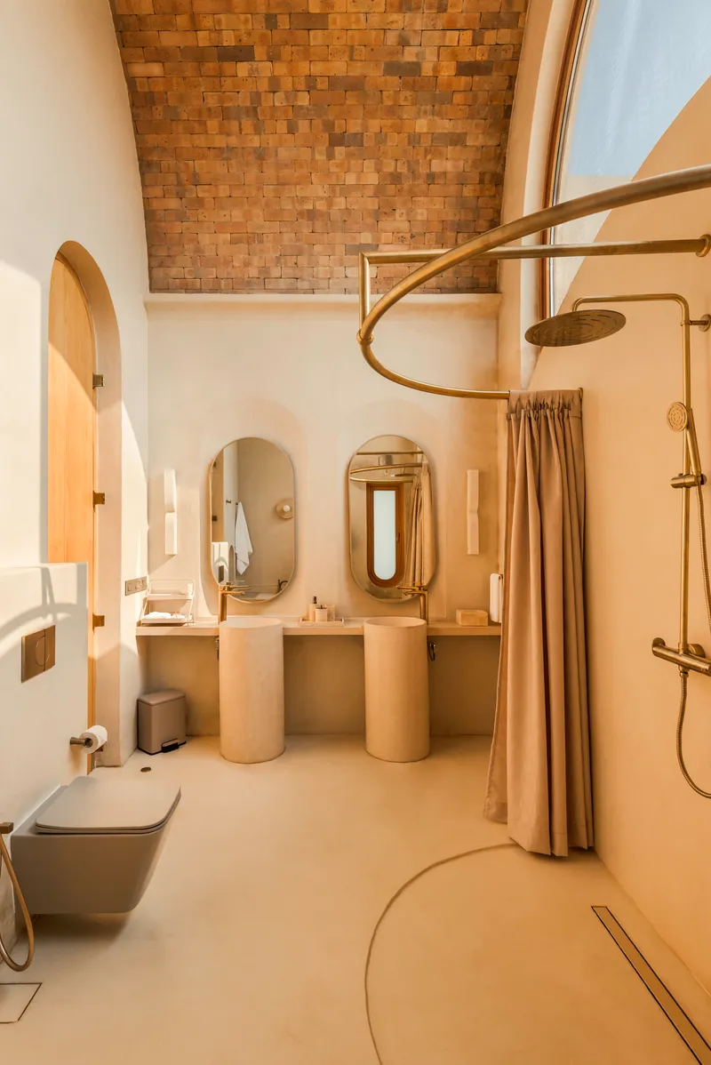 Bathroom interior with woven timber ceiling panel and polished plaster twin vanities