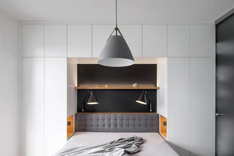 Integrated bedroom niche with soft lighting and built-in storage