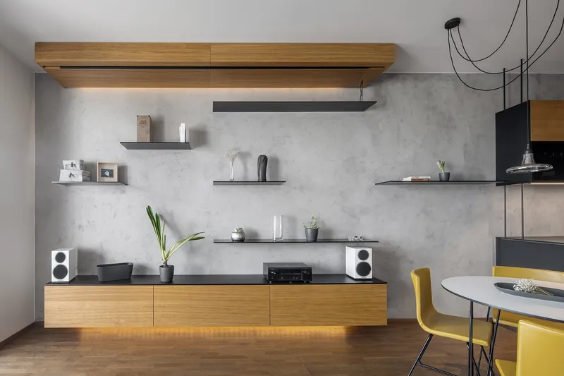 Minimal living wall with floating shelves and warm underlighting