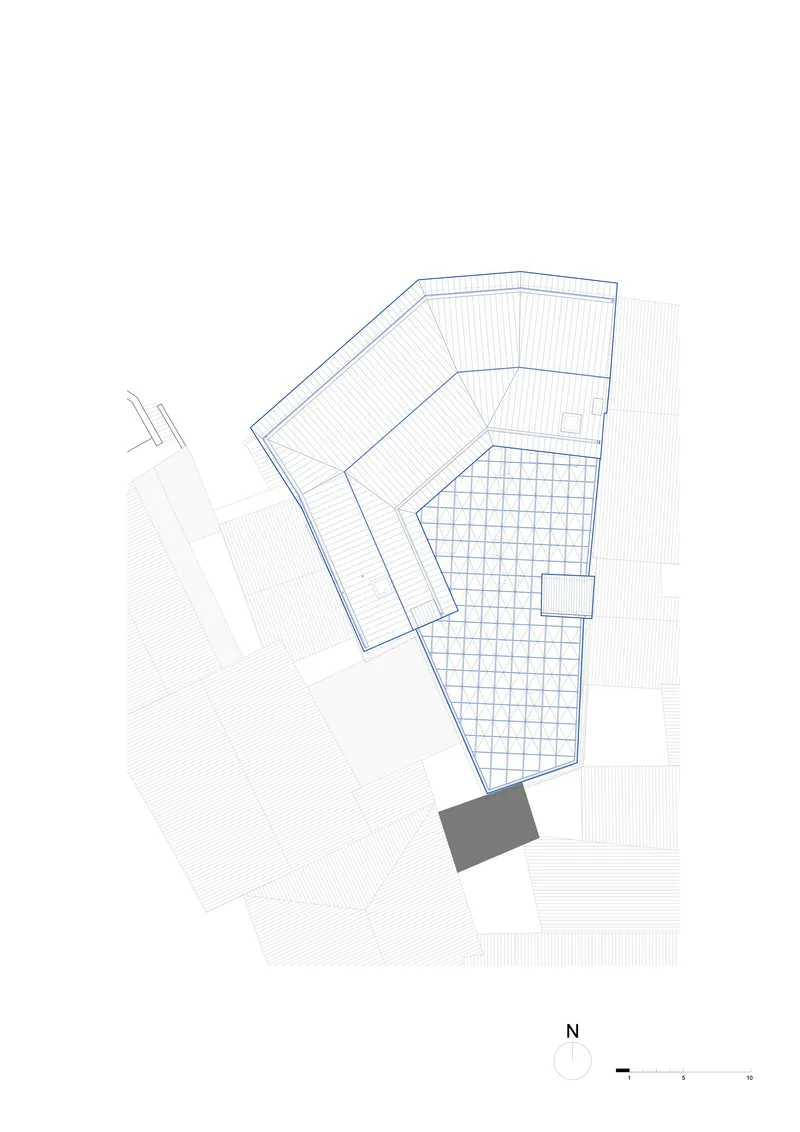 Roof plan drawing depicting folded planes above the gridded courtyard and surrounding volumes