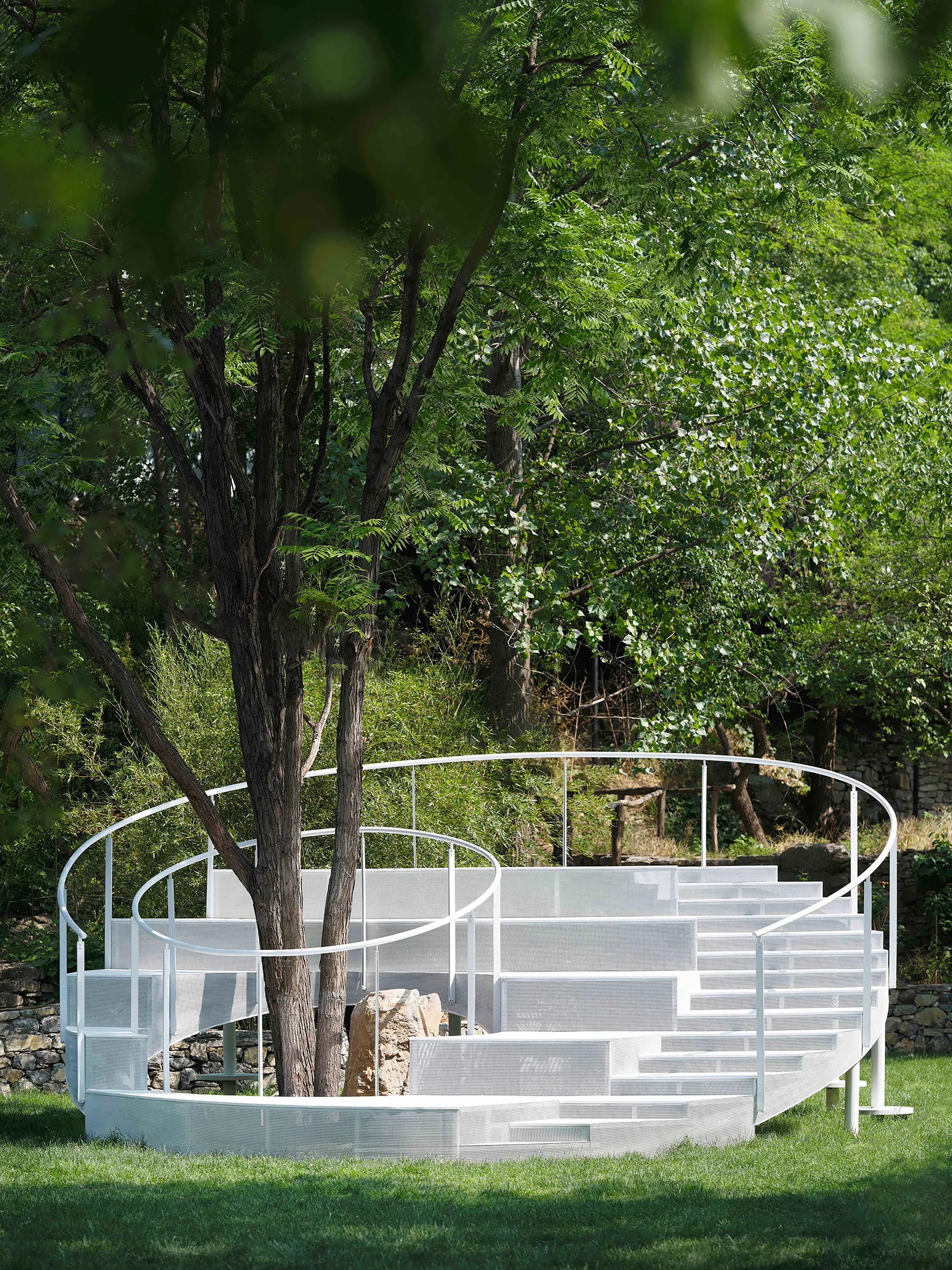 Studio Clash Wraps a White Steel Amphitheater Around Living Trees in Zibo