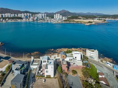 Hyunjoon Yoo Architects Anchor a Fragmented Coastal Village into Busan's Rocky Shoreline