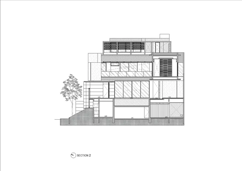 Section drawing showing layered interior spaces across four levels with rooftop solar panels