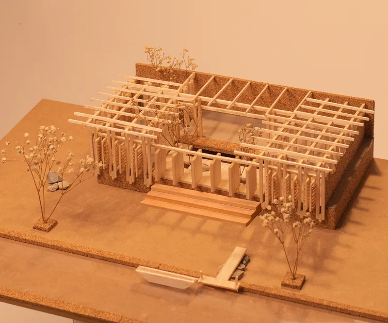 Physical model with exposed timber grid structure and planted courtyard under warm exhibition lighting