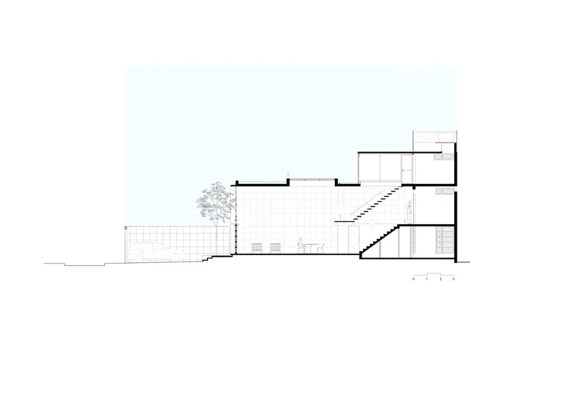 Section drawing showing a multi-level building with a central courtyard, diagonal staircase, and tree