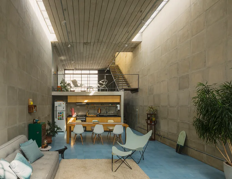 Living area with concrete block walls and continuous clerestory glazing along ceiling edge