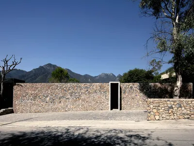 S-AR Builds a Courtyard House in Santiago That Frames Mountains Through Stone and Concrete