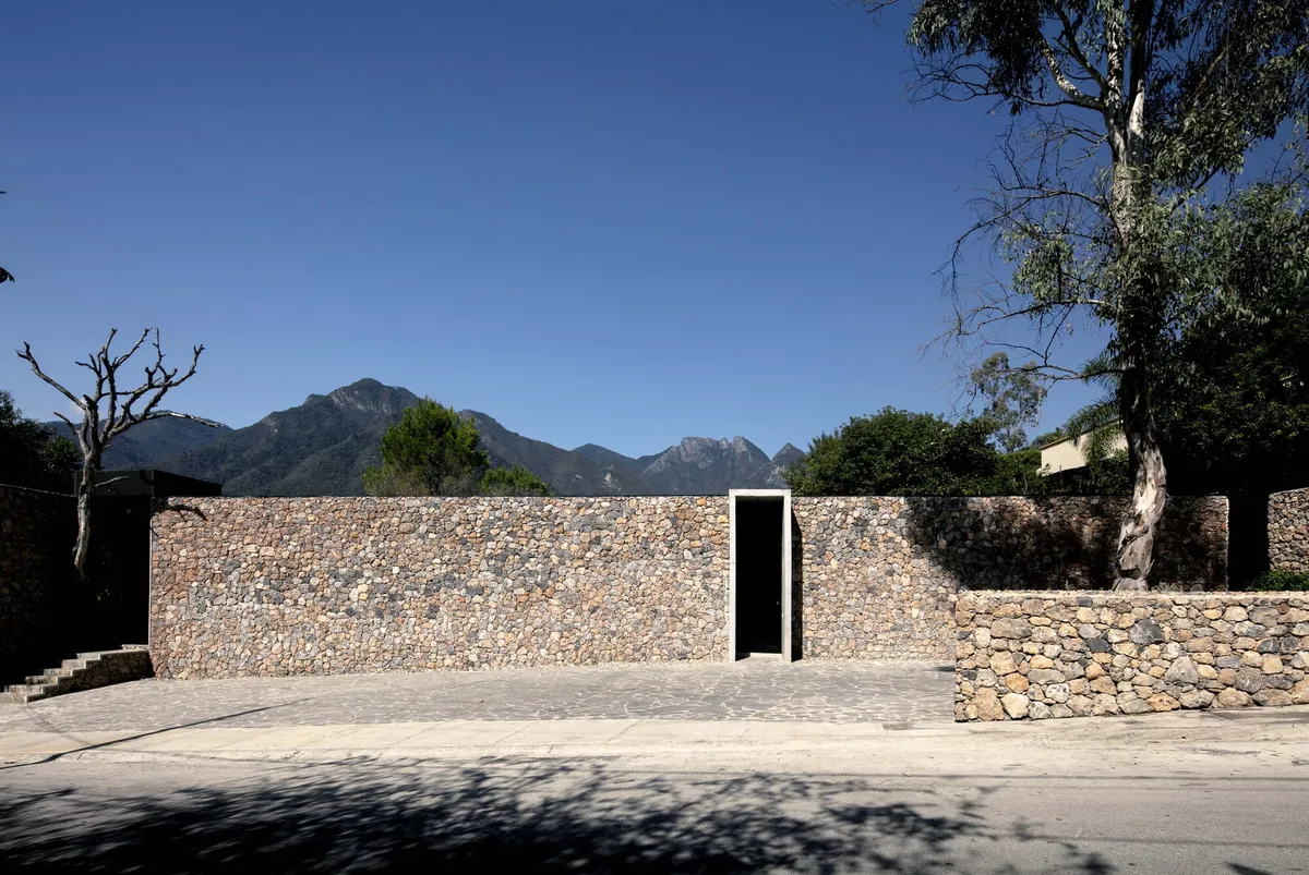 S-AR Builds a Courtyard House in Santiago That Frames Mountains Through Stone and Concrete