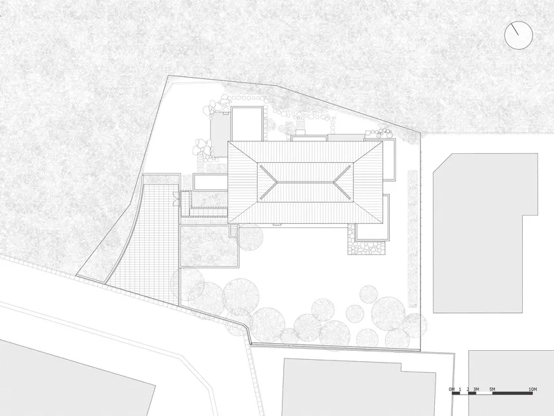Roof plan drawing showing the angled metal roofs and surrounding garden with trees