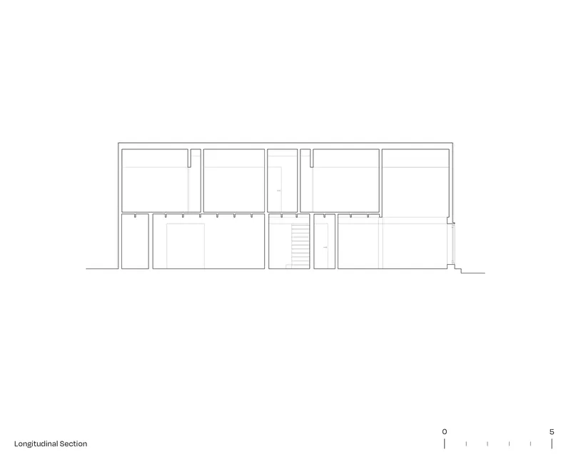 Longitudinal section drawing showing two-story interior volumes with central staircase and varied ceiling heights