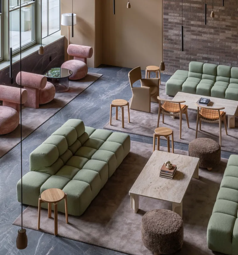 Overhead view of the lounge seating area arranged on grey and tan area rugs