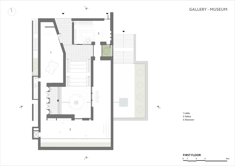 First floor plan showing lobby, gallery and showroom spaces with exterior planted areas