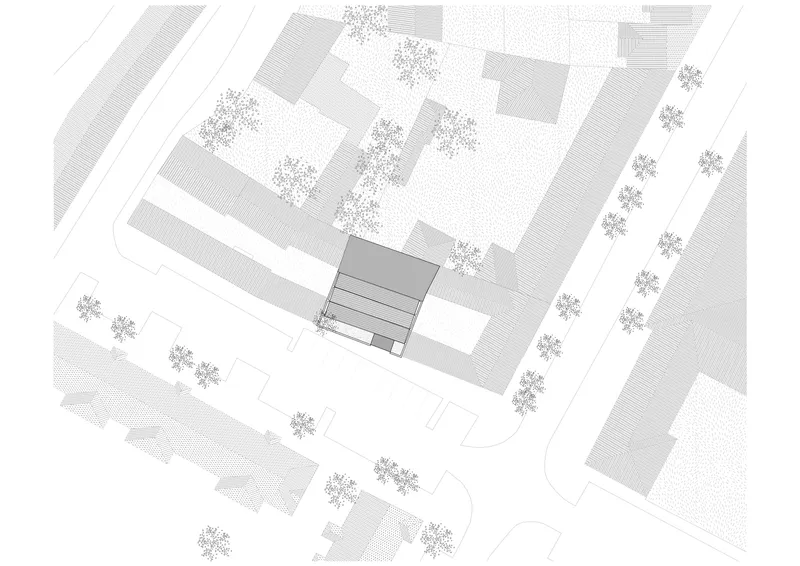 Axonometric site plan showing a building volume among neighboring structures and street trees