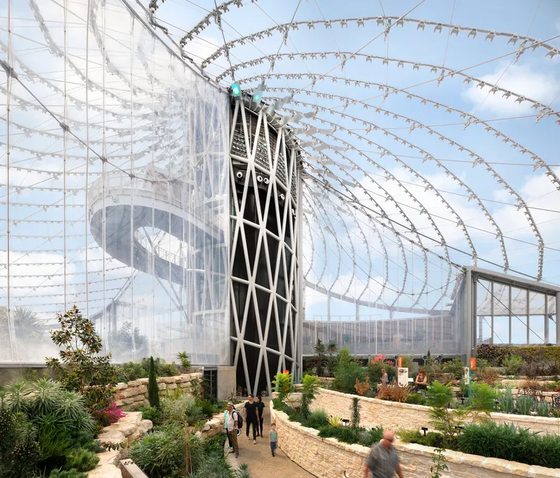 Diagonal-braced tower supporting the radiating cable net structure above terraced planted beds with visitors below