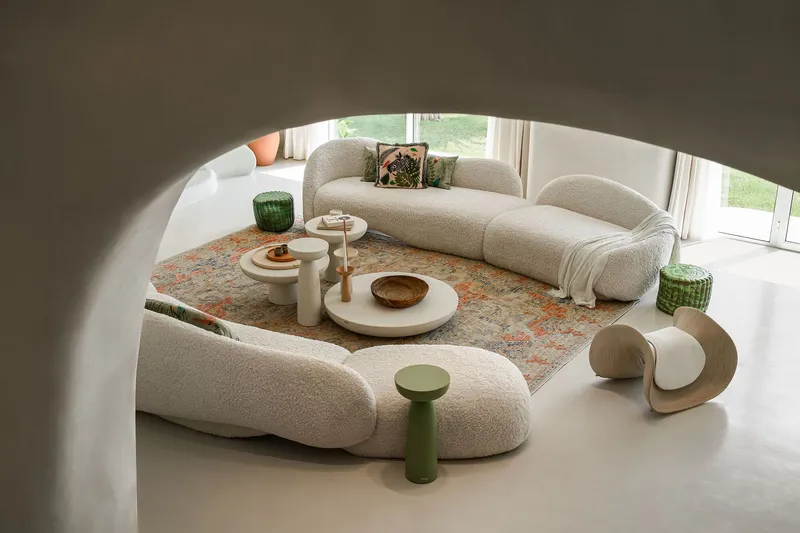 Overhead view of the sunken seating area with patterned rug and garden views through floor-to-ceiling windows