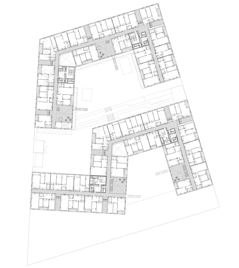 Floor plan drawing showing two L-shaped residential blocks with central courtyards and interior rooms