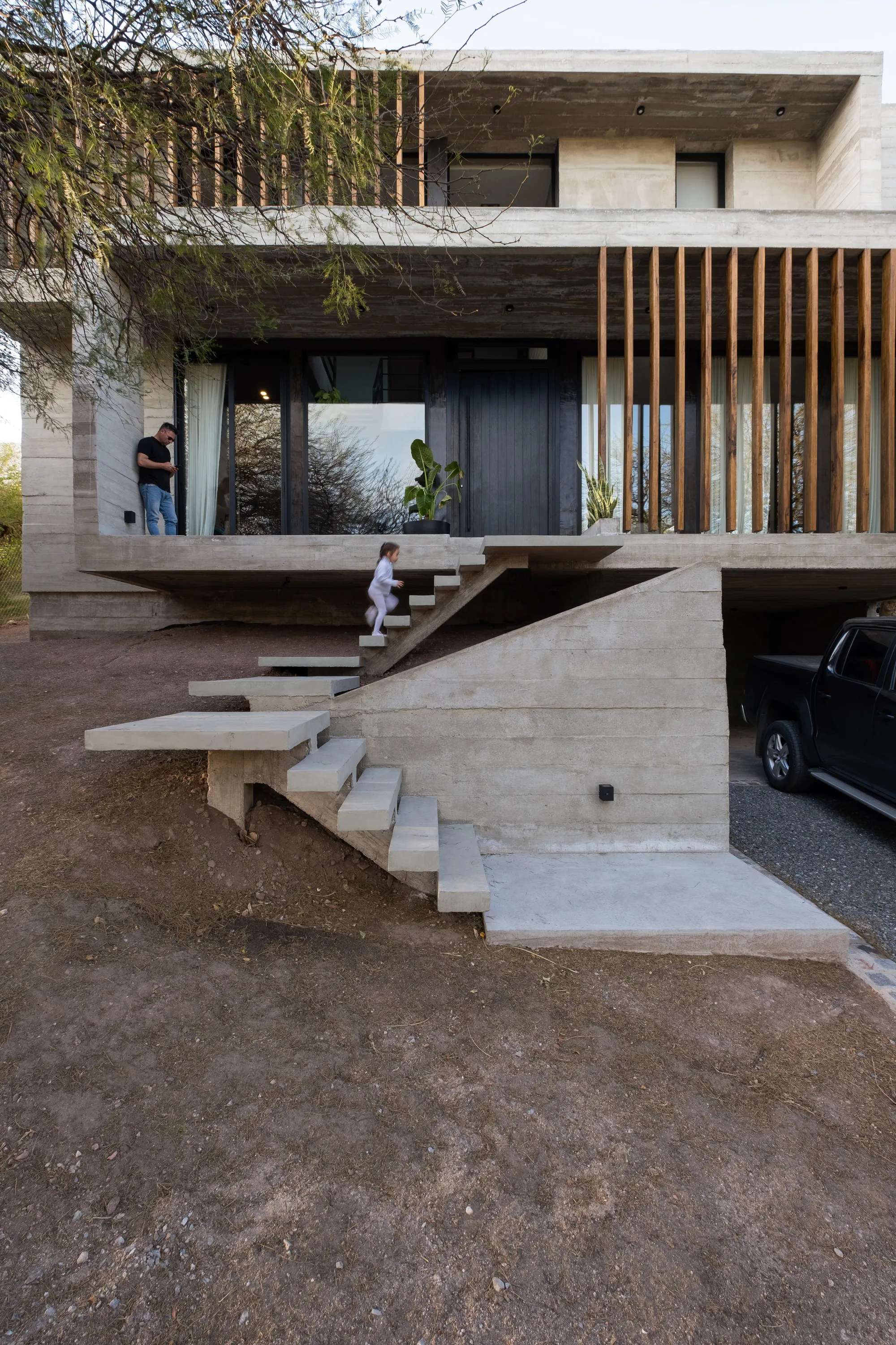 Pablo Senmartin Stacks Two Concrete Volumes on a Hillside to Fuse Home and Office in Córdoba