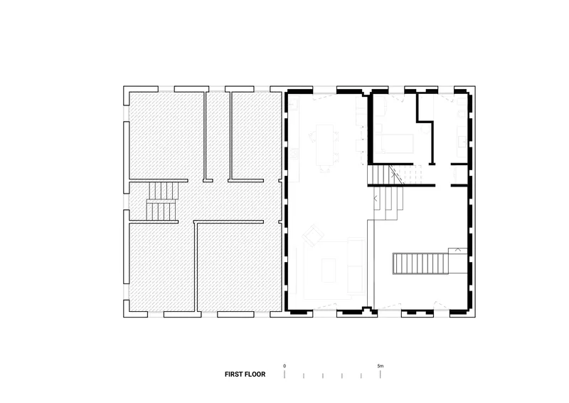 First floor plan drawing showing two mirrored units with staircases and hatched existing walls