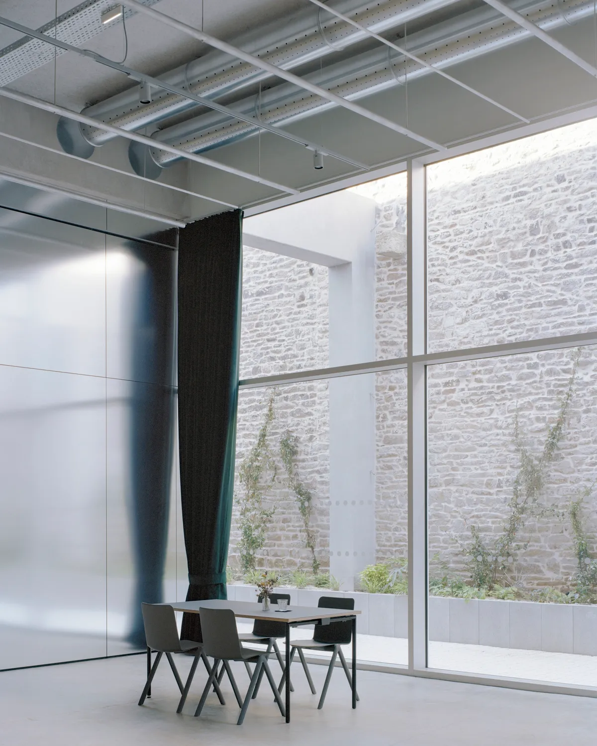 Office Zola Architectes Carves a Courtyard Out of a 44-Meter Industrial Hall in Vannes