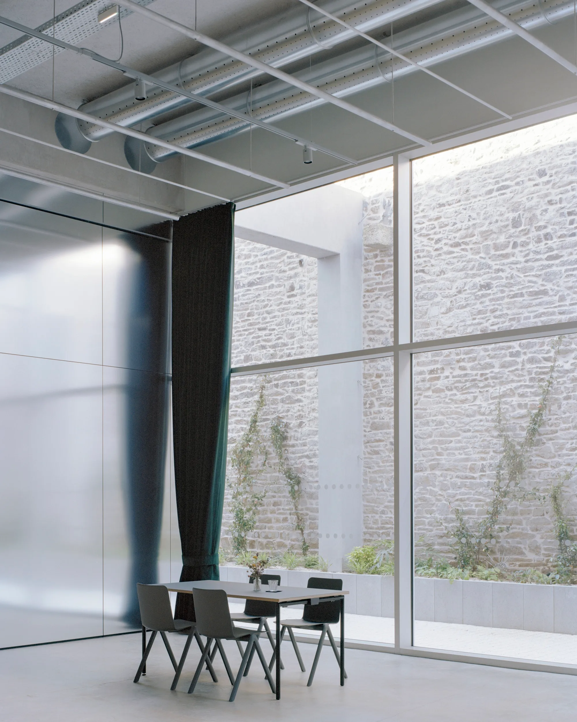 Office Zola Architectes Carves a Courtyard Out of a 44-Meter Industrial Hall in Vannes