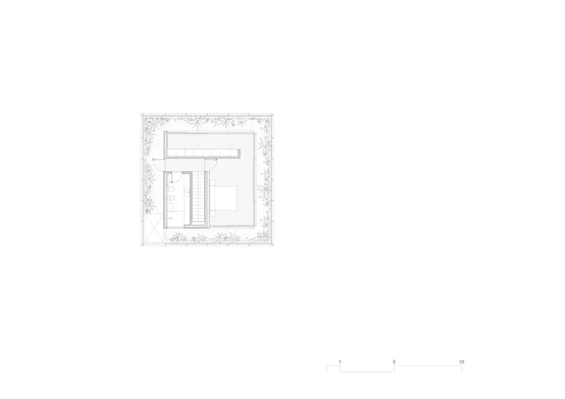 Site plan drawing showing the building footprint surrounded by landscaped areas with trees and plantings