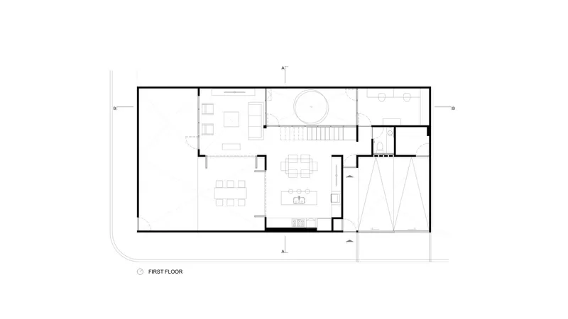 First floor plan drawing showing open living and dining areas with central circular stairwell