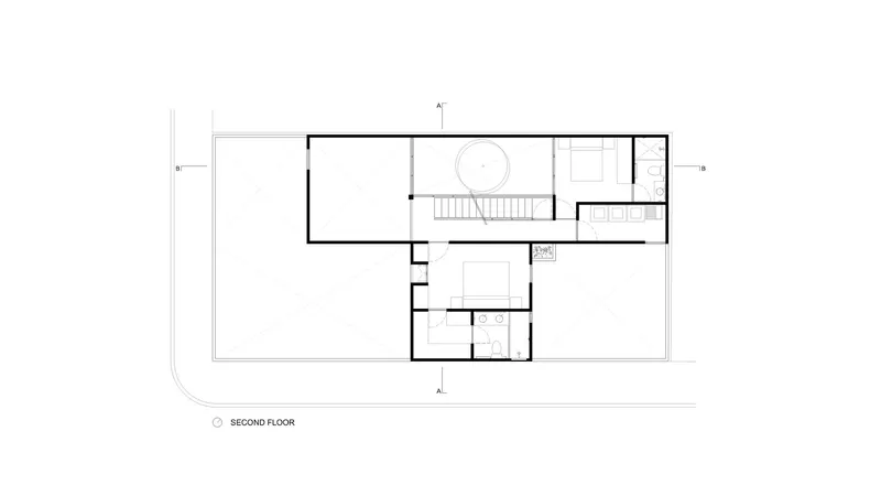 Second floor plan drawing showing bedroom spaces and central circular stairwell
