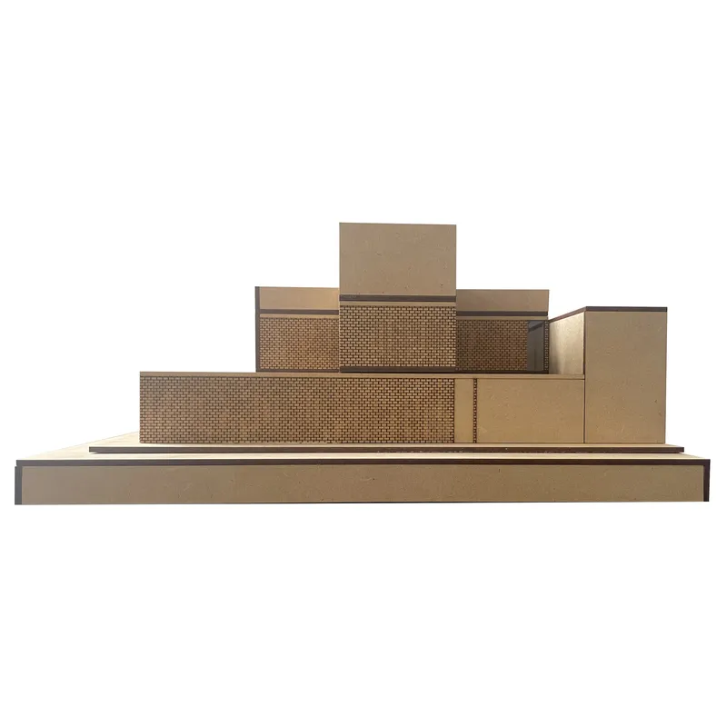 Elevation view of the physical model displaying layered volumes with perforated screens and solid blocks in neutral tones