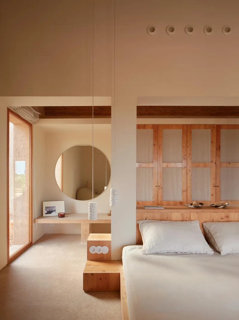 Bedroom with timber platform bed and built-in wardrobe beneath exposed wooden ceiling beams