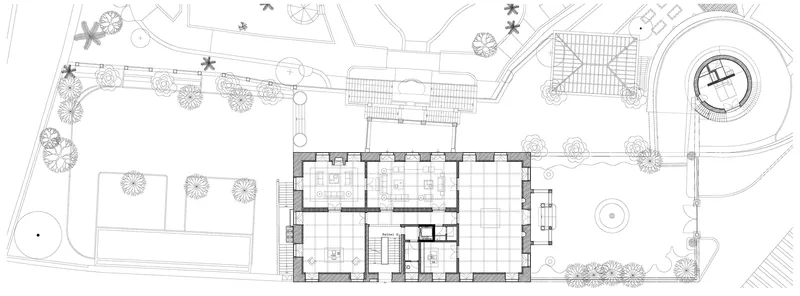 Ground floor plan drawing showing interior room layouts and surrounding landscaped grounds