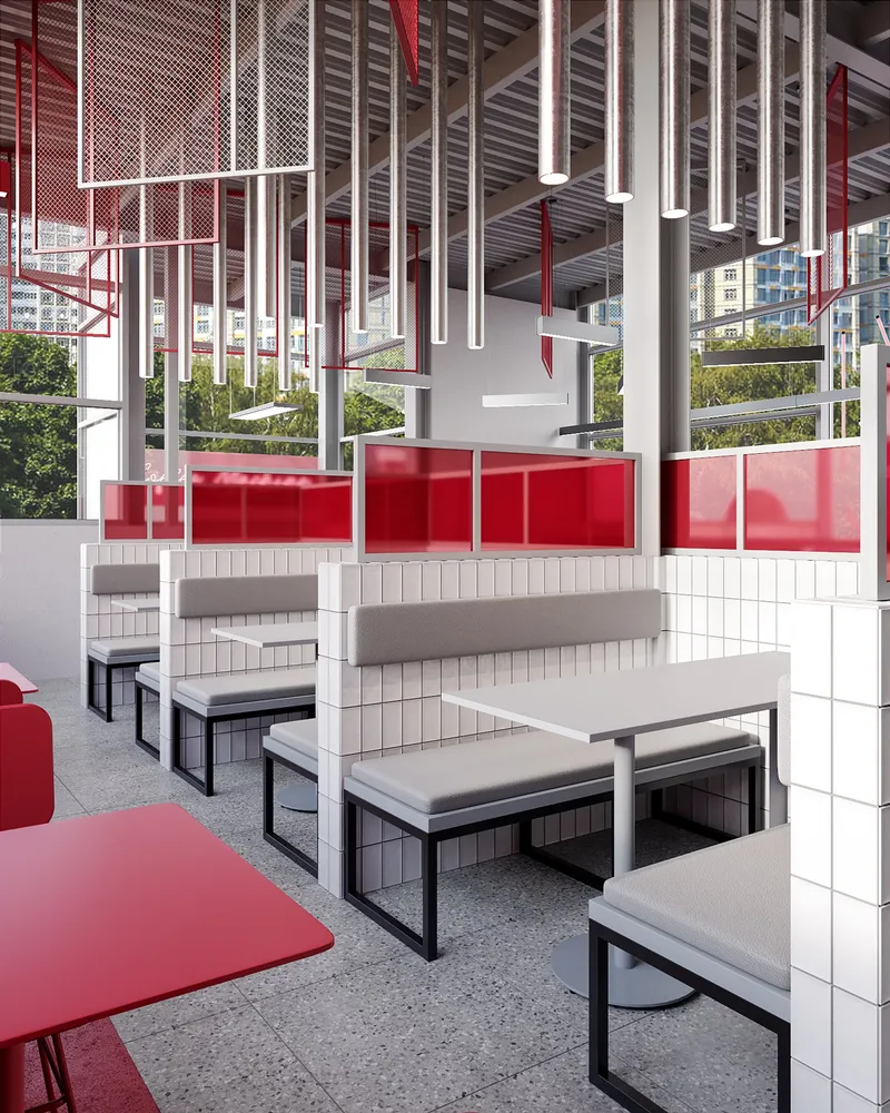 Modular booth seating framed by translucent red partitions and suspended lighting grid.