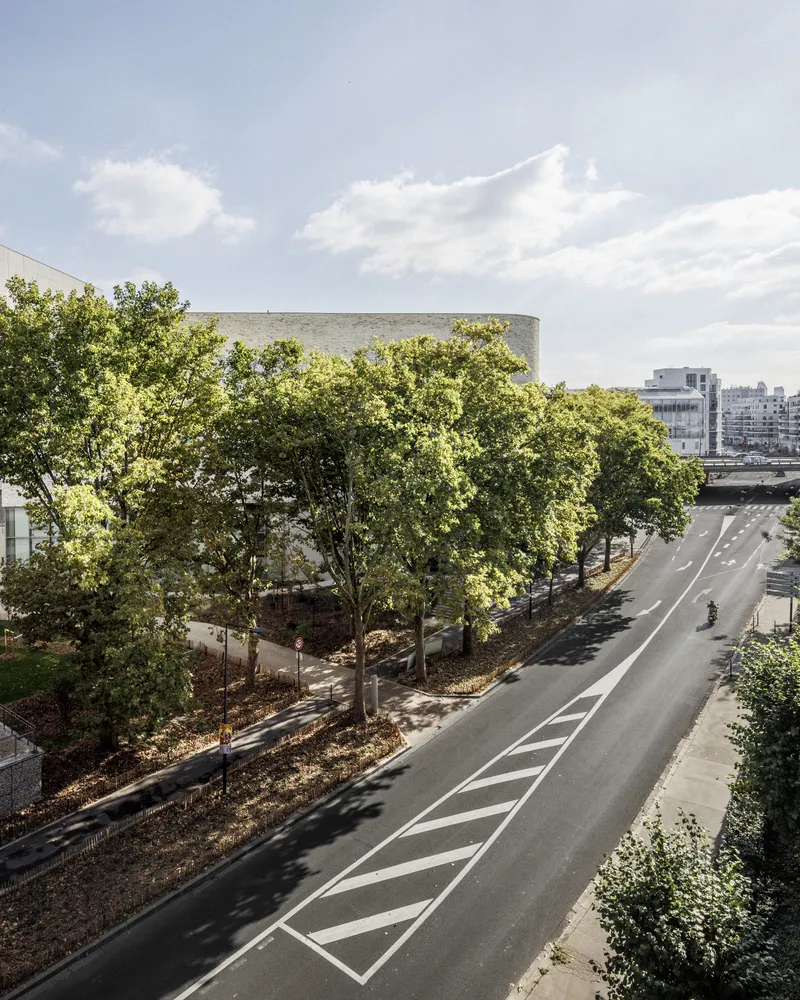 Elevated view of the street and landscaped perimeter with the curved building beyond
