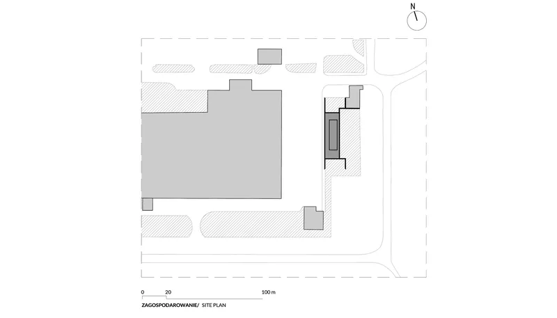 Site plan drawing showing rectangular building volume and smaller secondary structure on corner lot