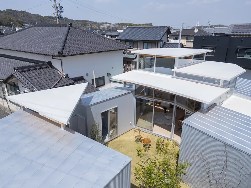 Aerial view of the clustered roof volumes wrapping around a central courtyard garden