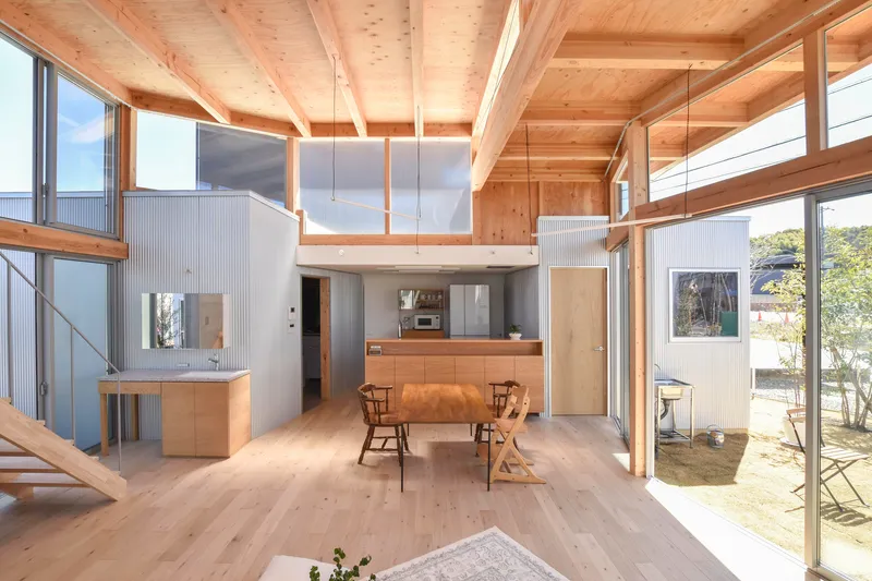 Timber-framed mezzanine level overlooking the dining area and courtyard garden beyond
