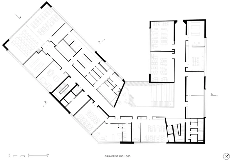 Second floor plan drawing showing angled volumes with open gathering spaces and service rooms