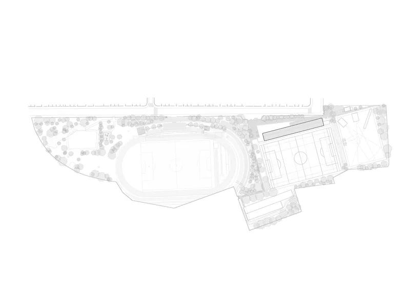 Site plan drawing showing an oval athletic field, adjacent building volumes, and landscaped areas