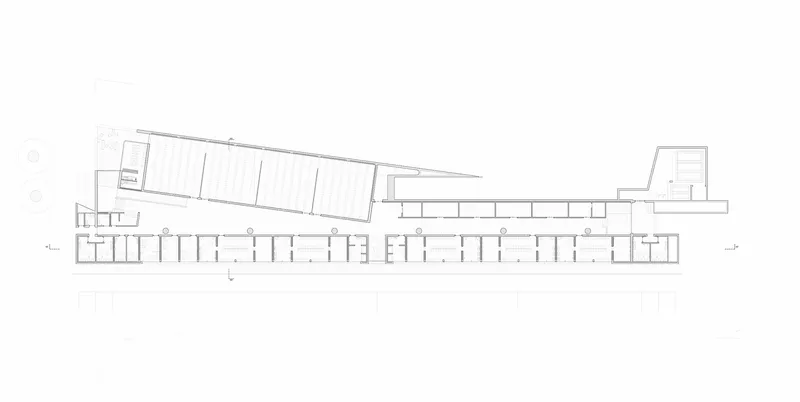 Floor plan drawing depicting a linear arrangement of rooms with angled volumes at each end