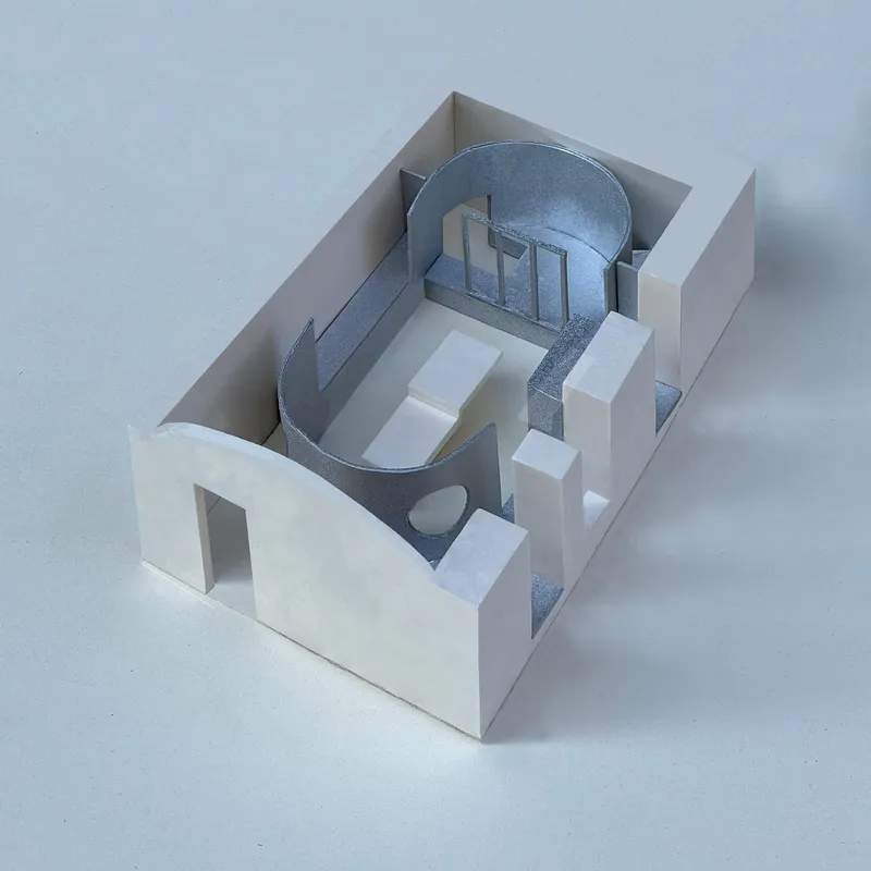 Physical model revealing the oval vault and rectangular enclosure with white and grey materials
