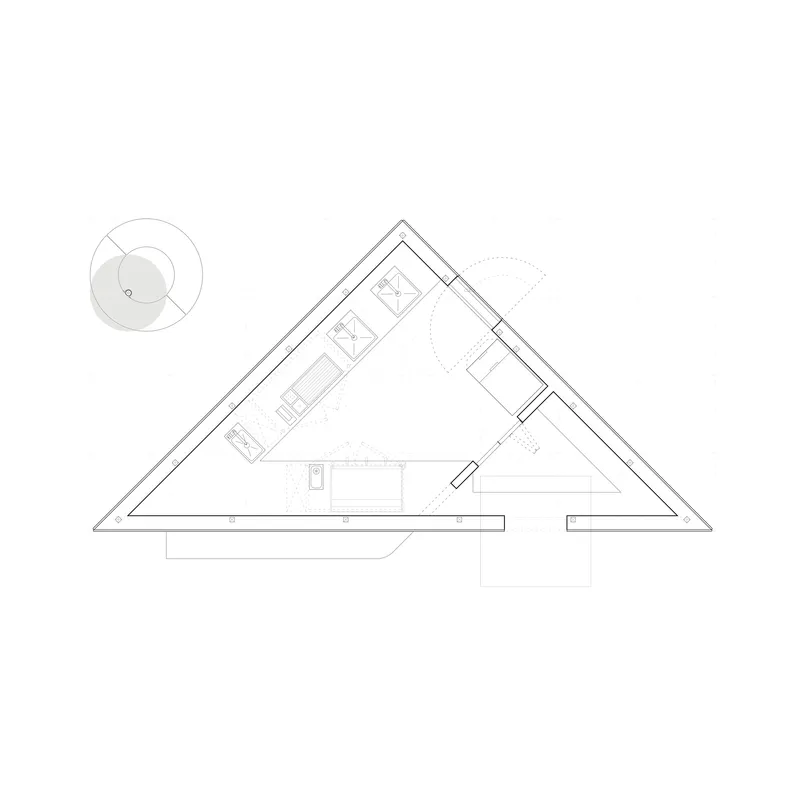 Floor plan drawing showing a triangular structure with interior rooms and a circular element to the left
