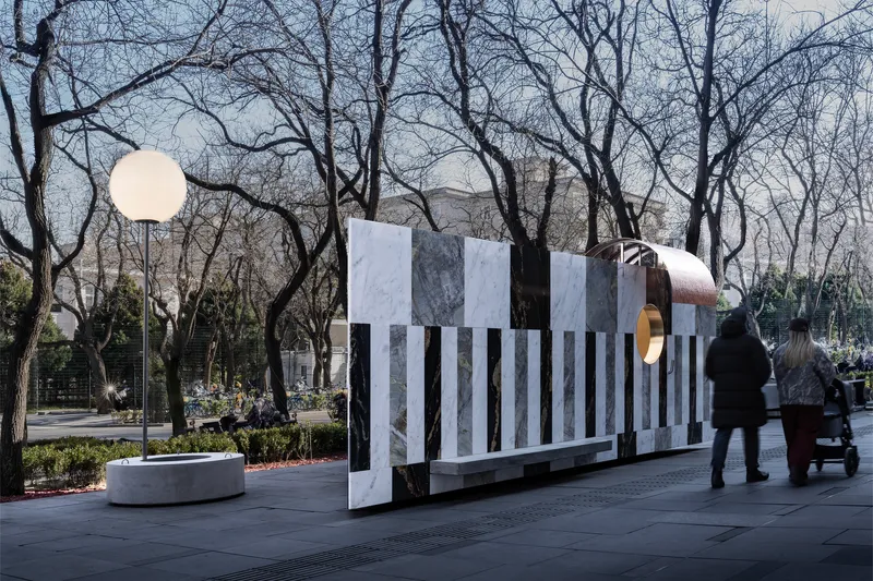 Side elevation of the installation showing the repetitive marble slat rhythm as visitors walk past with a stroller