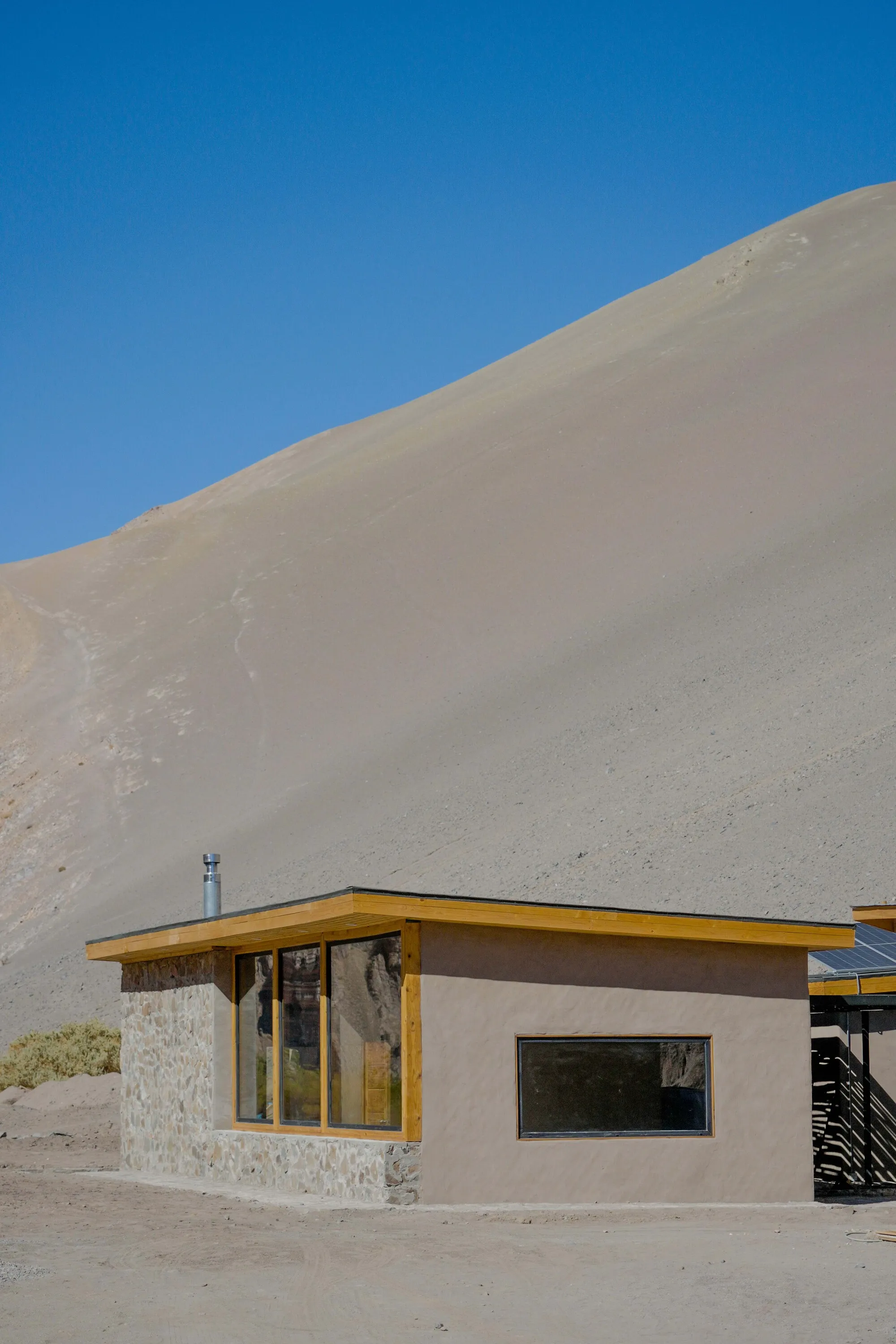 Arquitika Plants a Stone Research Center at the Foot of an Atacama Sand Dune for the Colla Community