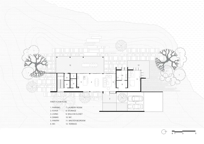 First floor plan drawing showing open living and dining spaces with terraces and surrounding trees